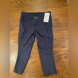 NWOT. Navy salutation stash pocket capris. Size L. Tag removed but never worn.